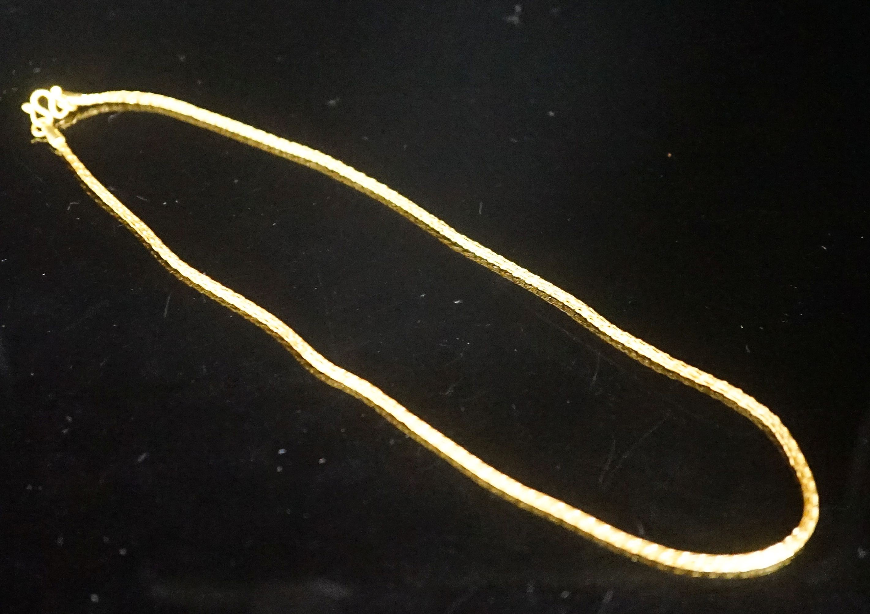 A continental yellow metal necklace, 38cm, 7.7 grams.